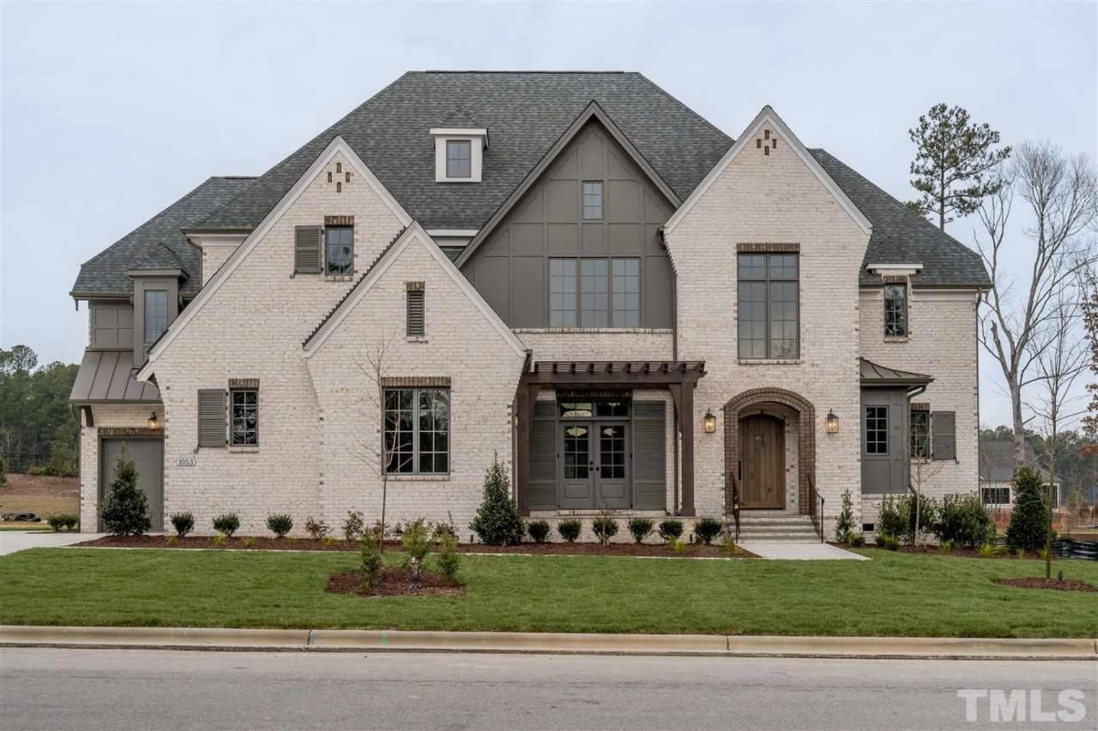 Elegant Tudor-Style House Plan with Luxurious Layout