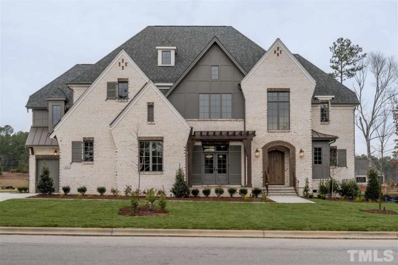 Elegant Tudor-Style House Plan with Luxurious Layout